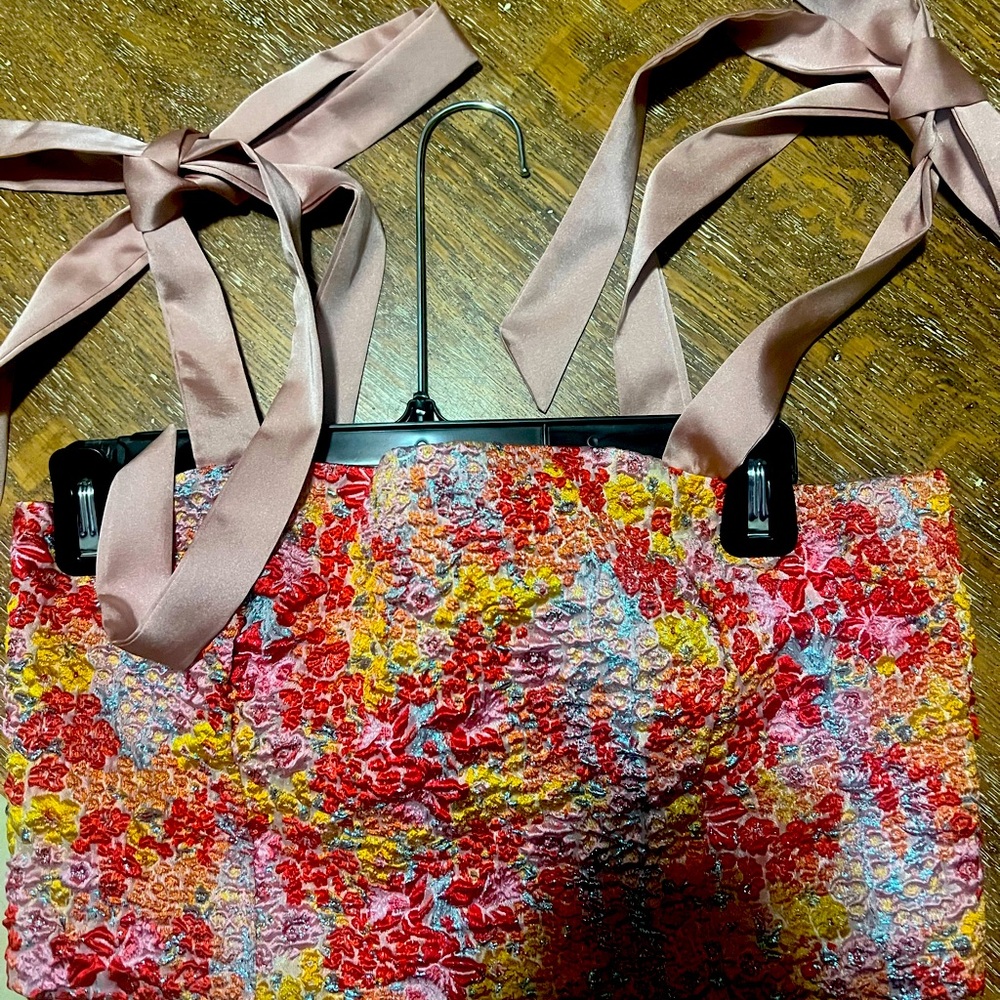 This is a two-piece set tie top on shoulder with matching below the knee skirt.